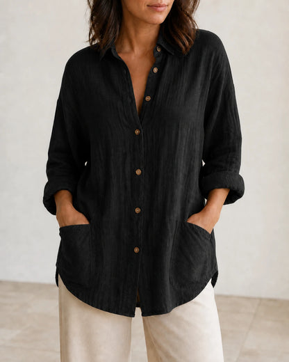 Women's black relaxed longline shirt, front product view.